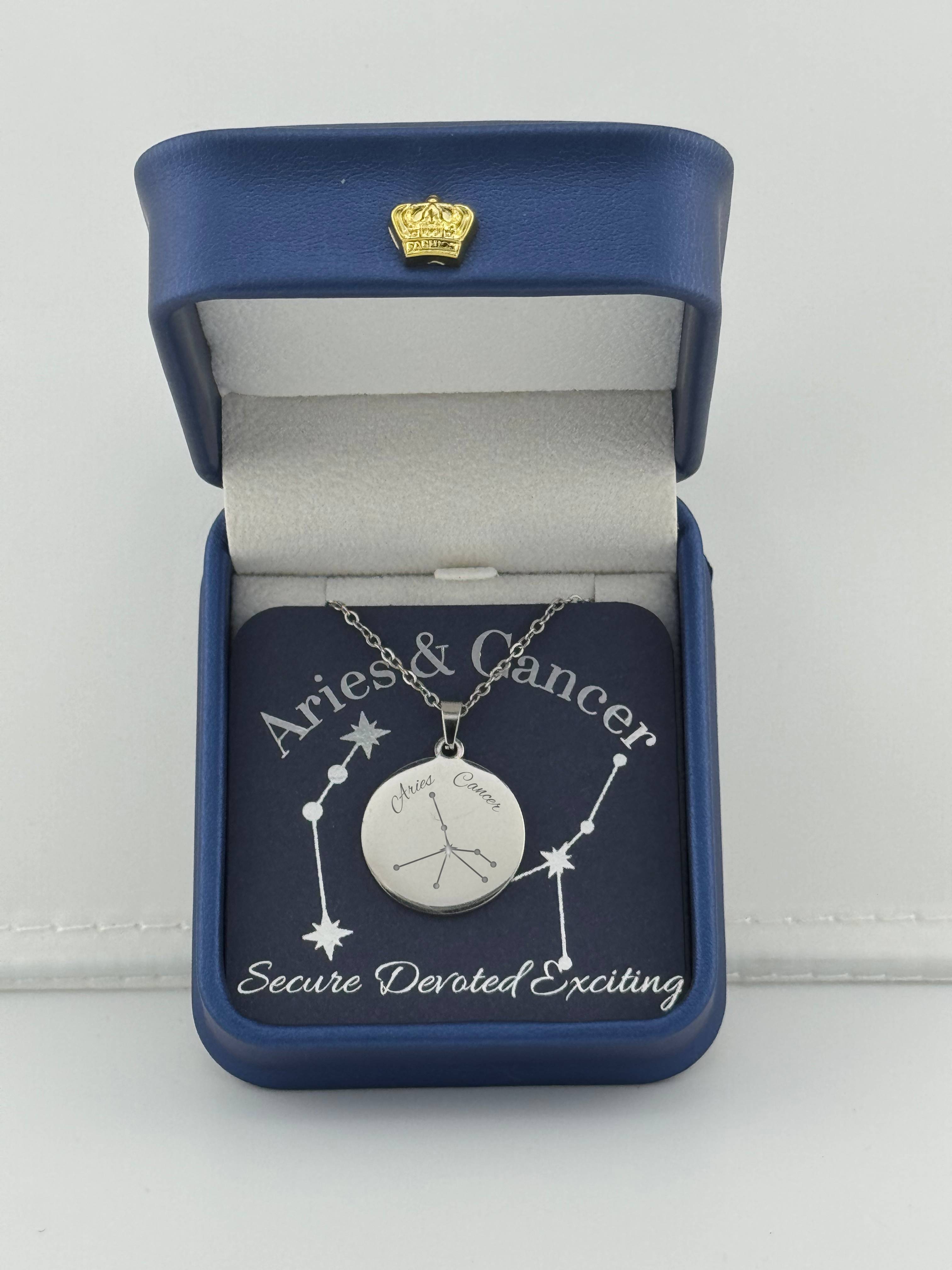 Silver Aries + Cancer constellation medallion necklace in gift box with silver foil zodiac card
