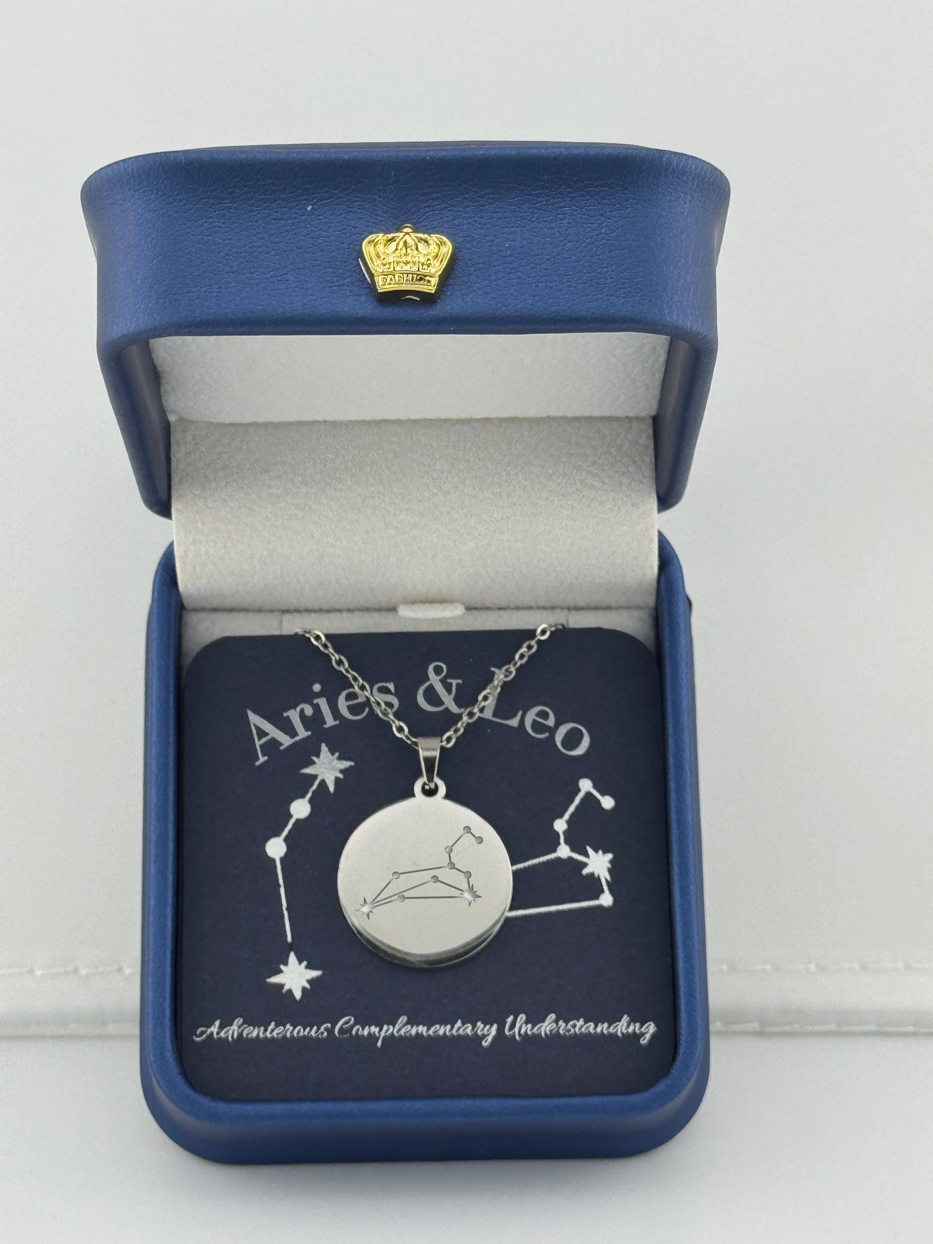 Silver Aries + Leo constellation medallion necklace in gift box with silver foil zodiac card
