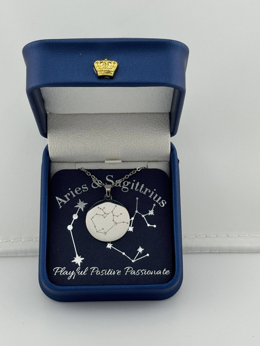 Silver Aries + Sagittarius constellation medallion necklace in gift box with silver foil zodiac card
