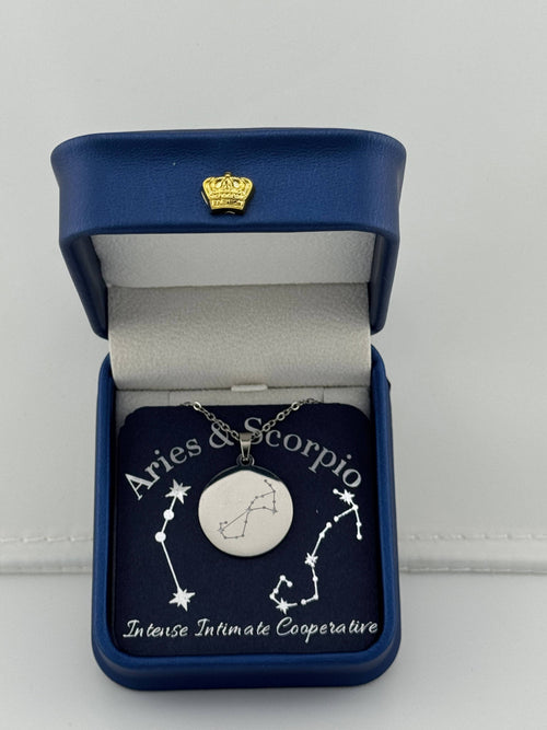 Silver Aries + Scorpio constellation medallion necklace in gift box with silver foil zodiac card
