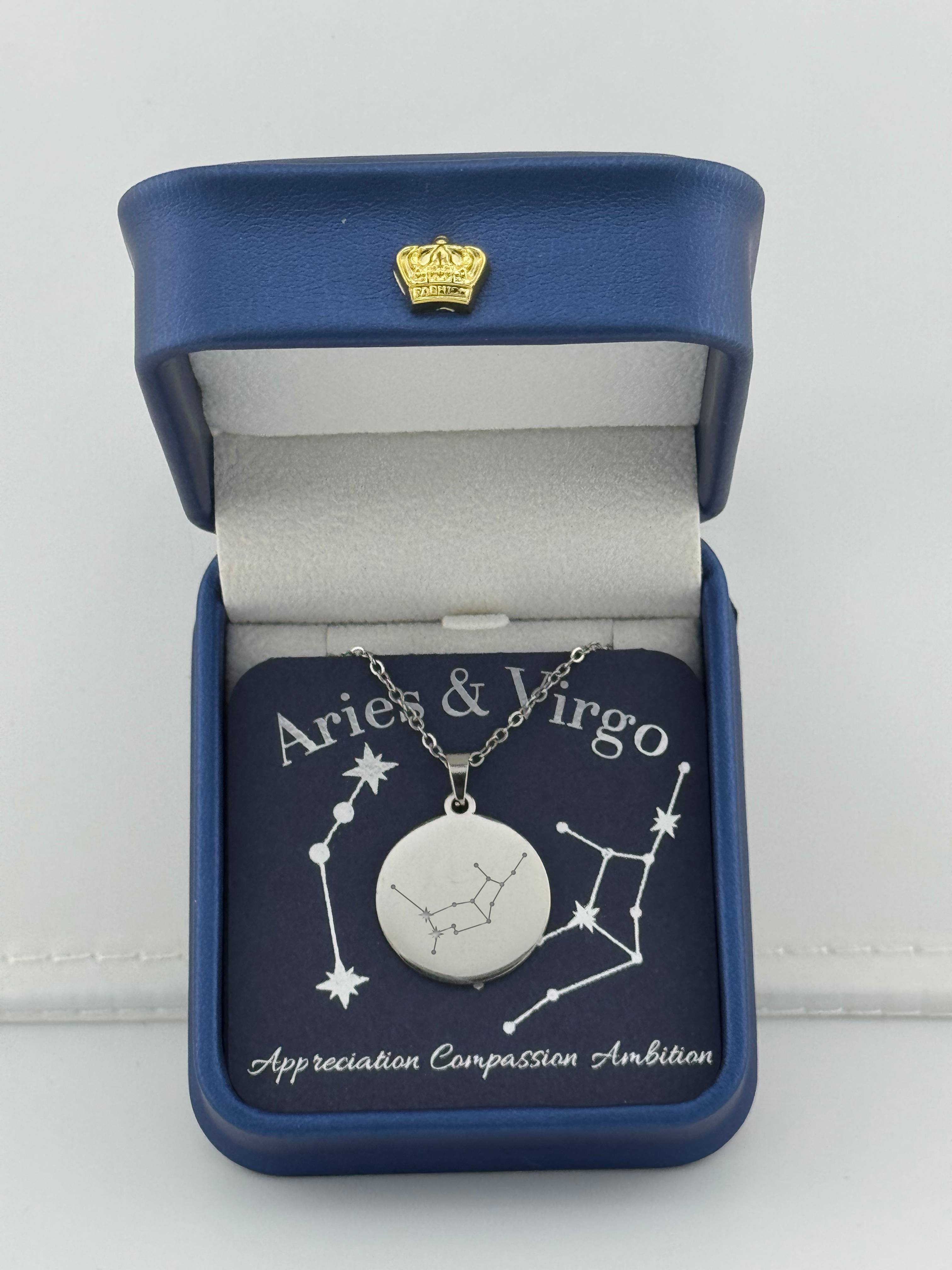 Silver Aries + Virgo constellation medallion necklace in gift box with silver foil zodiac card.
