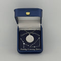 Silver Cancer and Capricorn constellation medallion necklace in gift box with silver foil zodiac card
