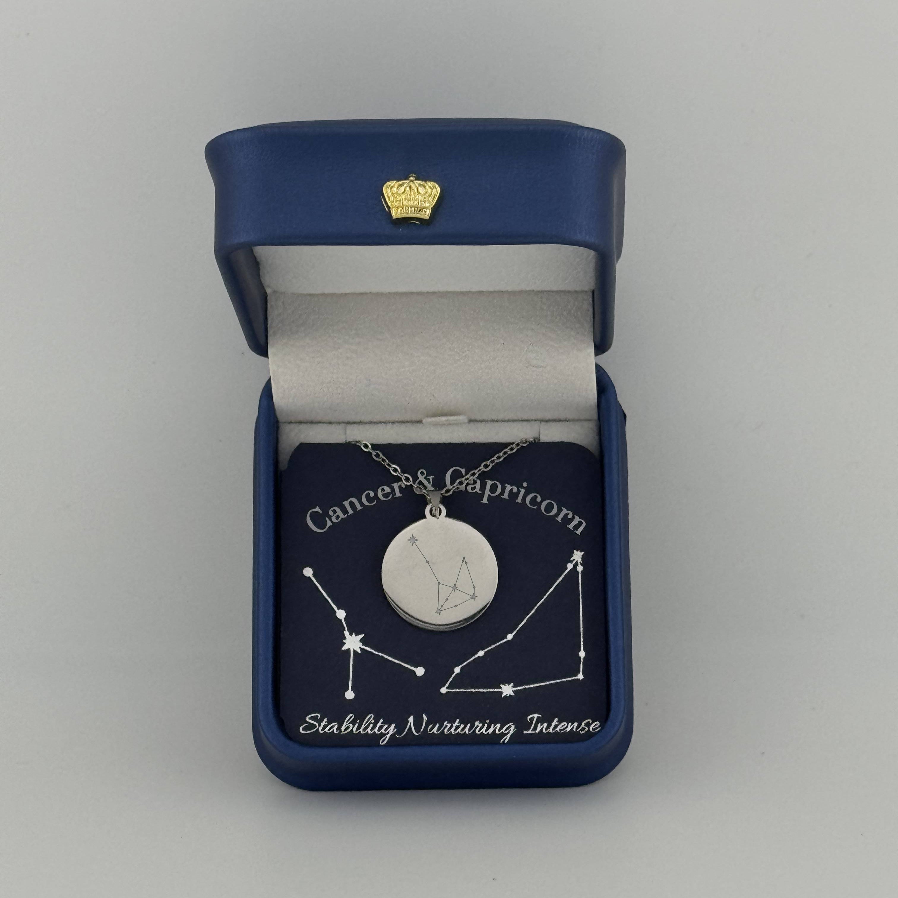 Silver Cancer and Capricorn constellation medallion necklace in gift box with silver foil zodiac card
