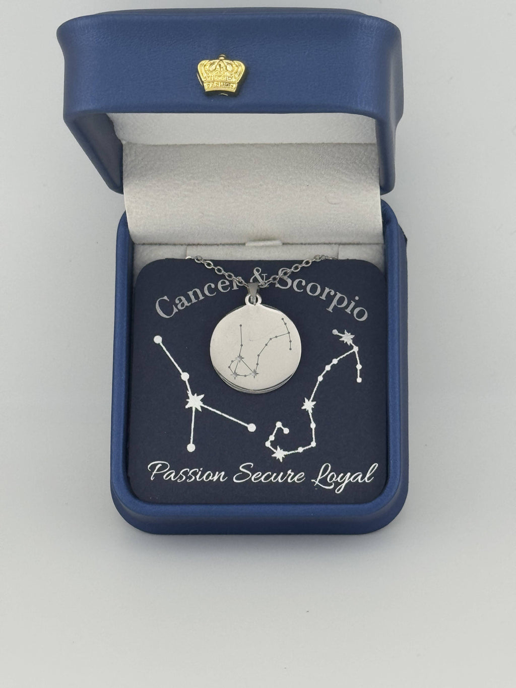 Silver Cancer and Scorpio constellation medallion necklace in gift box with silver foil zodiac card
