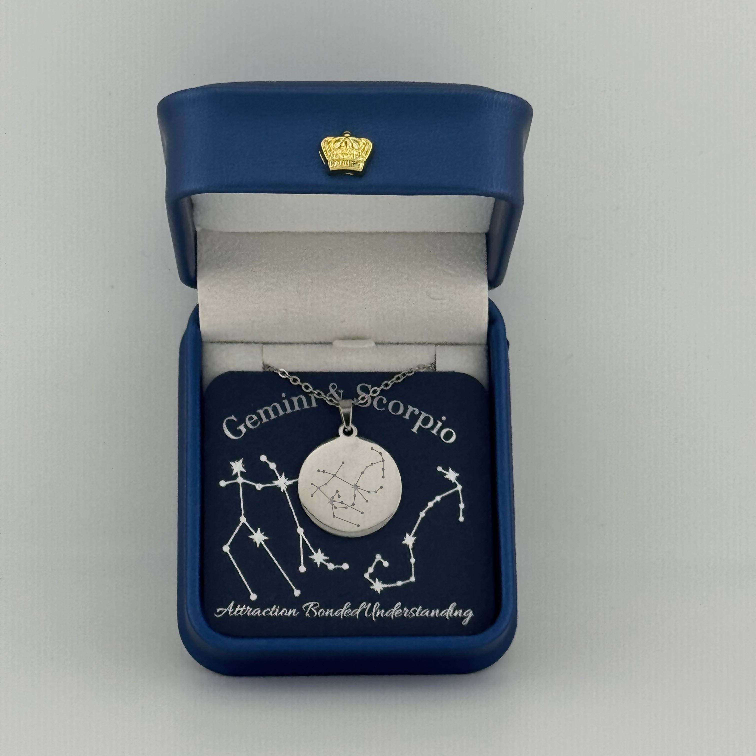 Silver Gemini + Scorpio constellation medallion necklace in gift box with silver foil zodiac card
