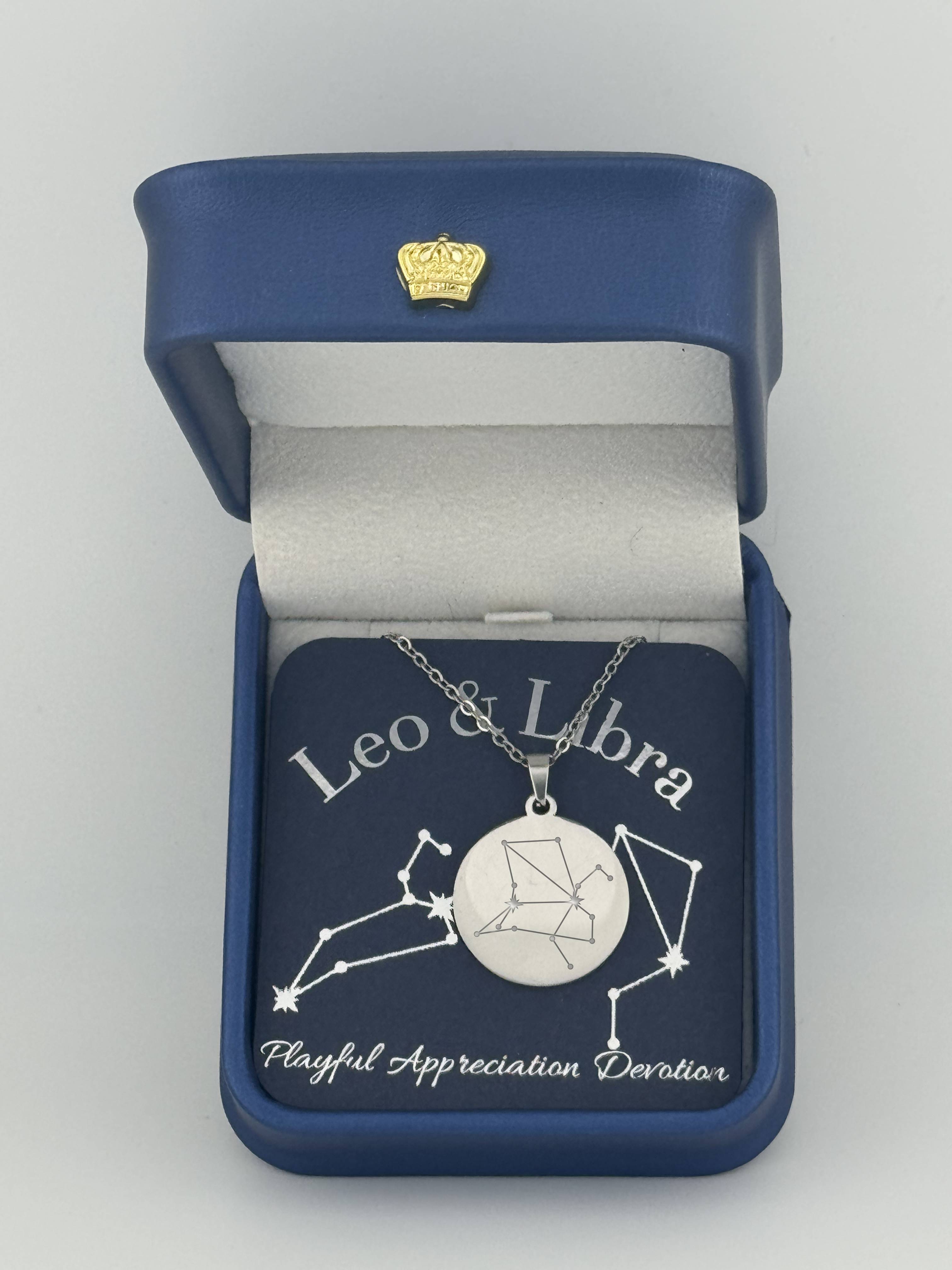 Silver Leo and Libra constellation medallion necklace in gift box with silver foil zodiac card

