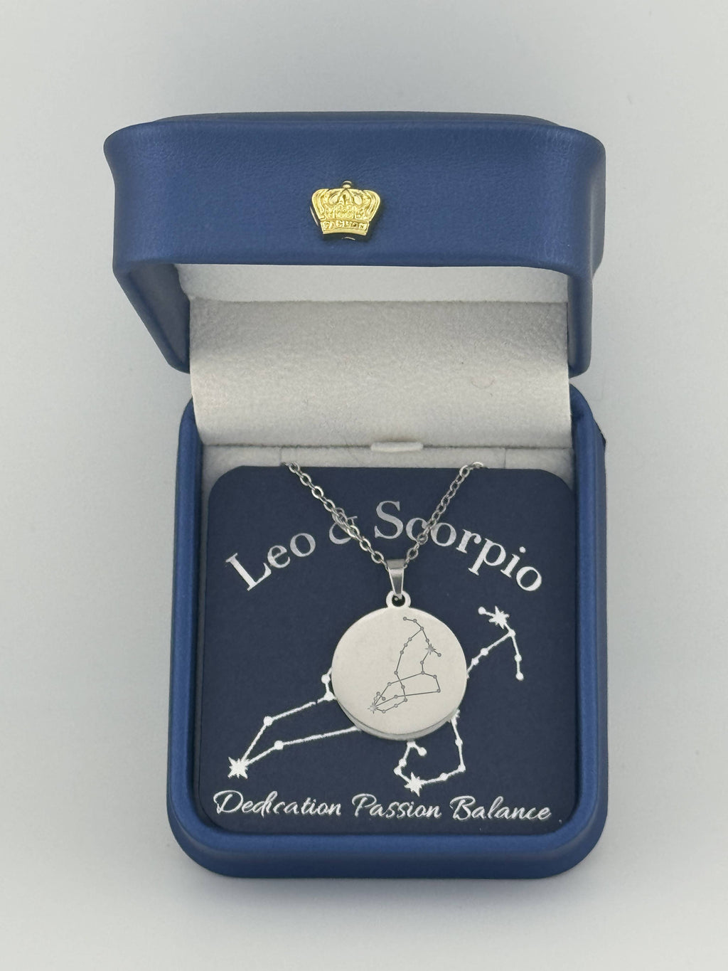 Silver Leo and Scorpio constellation medallion necklace in gift box with silver foil zodiac card
