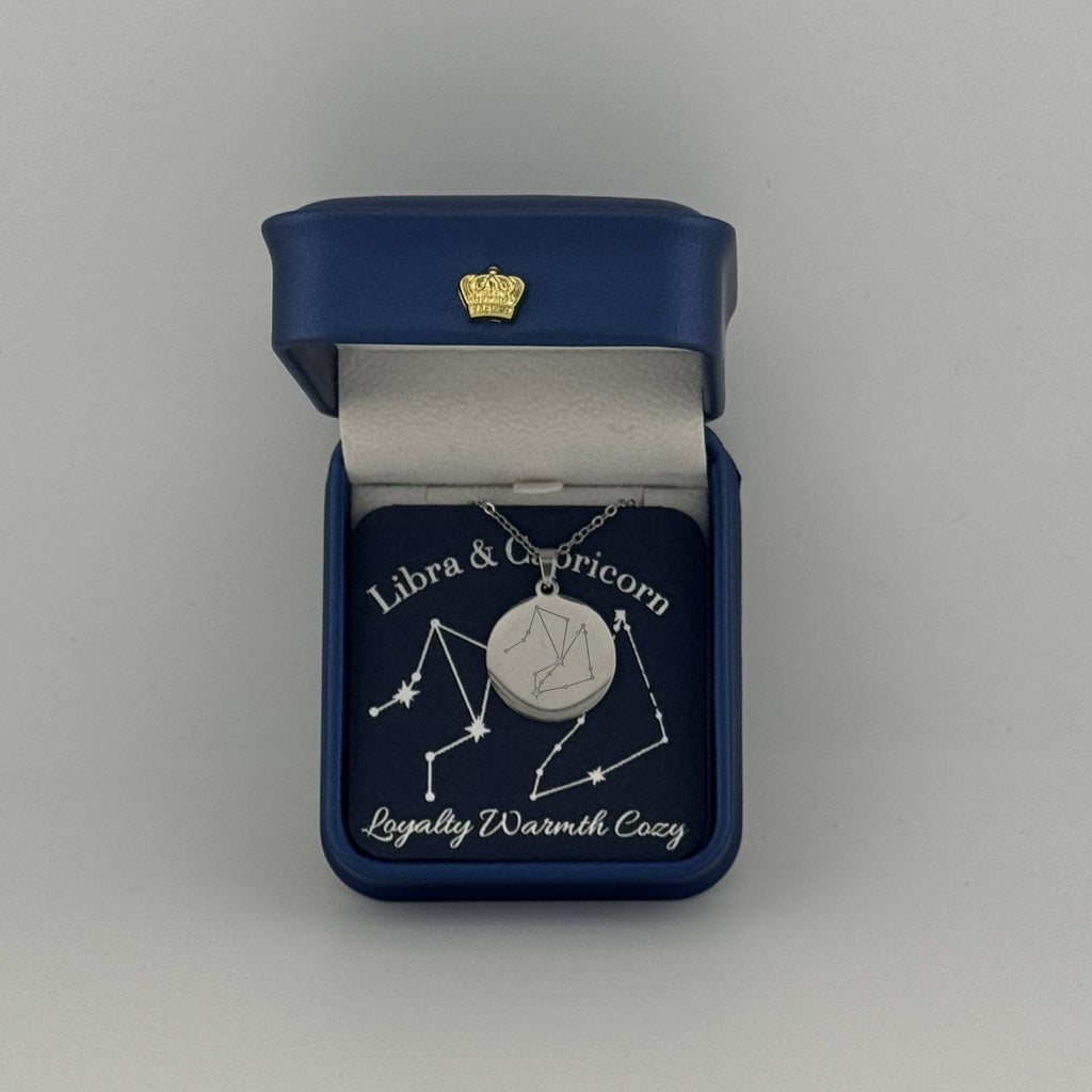 Silver Libra and Capricorn constellation medallion necklace in gift box with silver foil zodiac card
