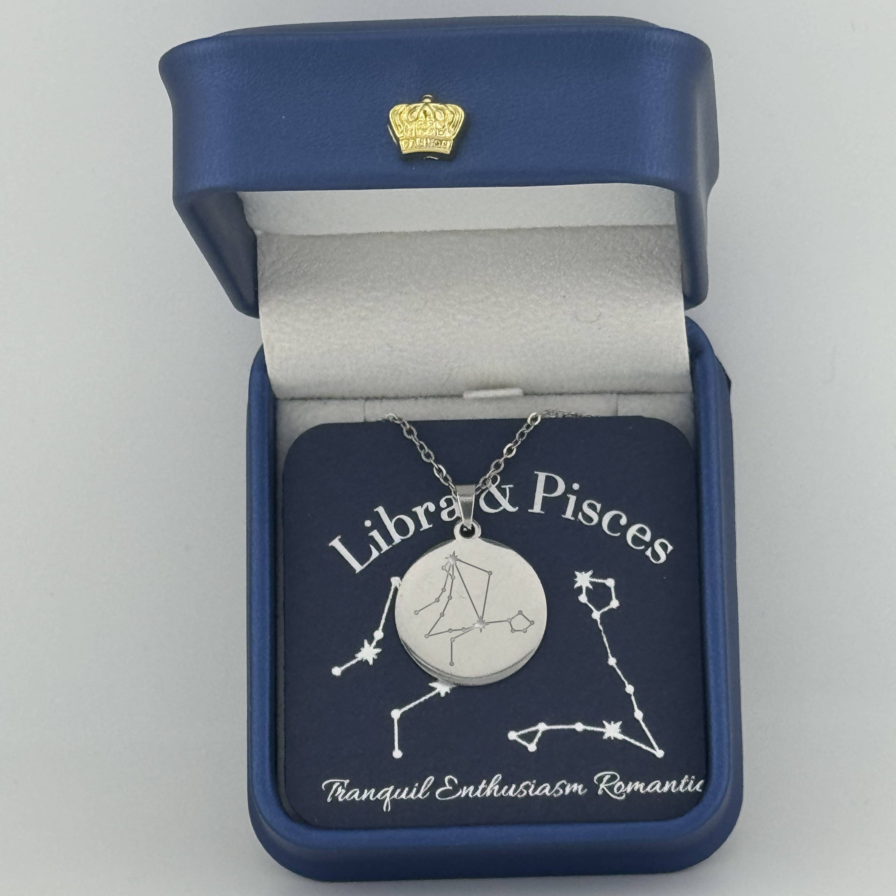 Silver Libra and Pisces constellation medallion necklace in gift box with silver foil zodiac card
