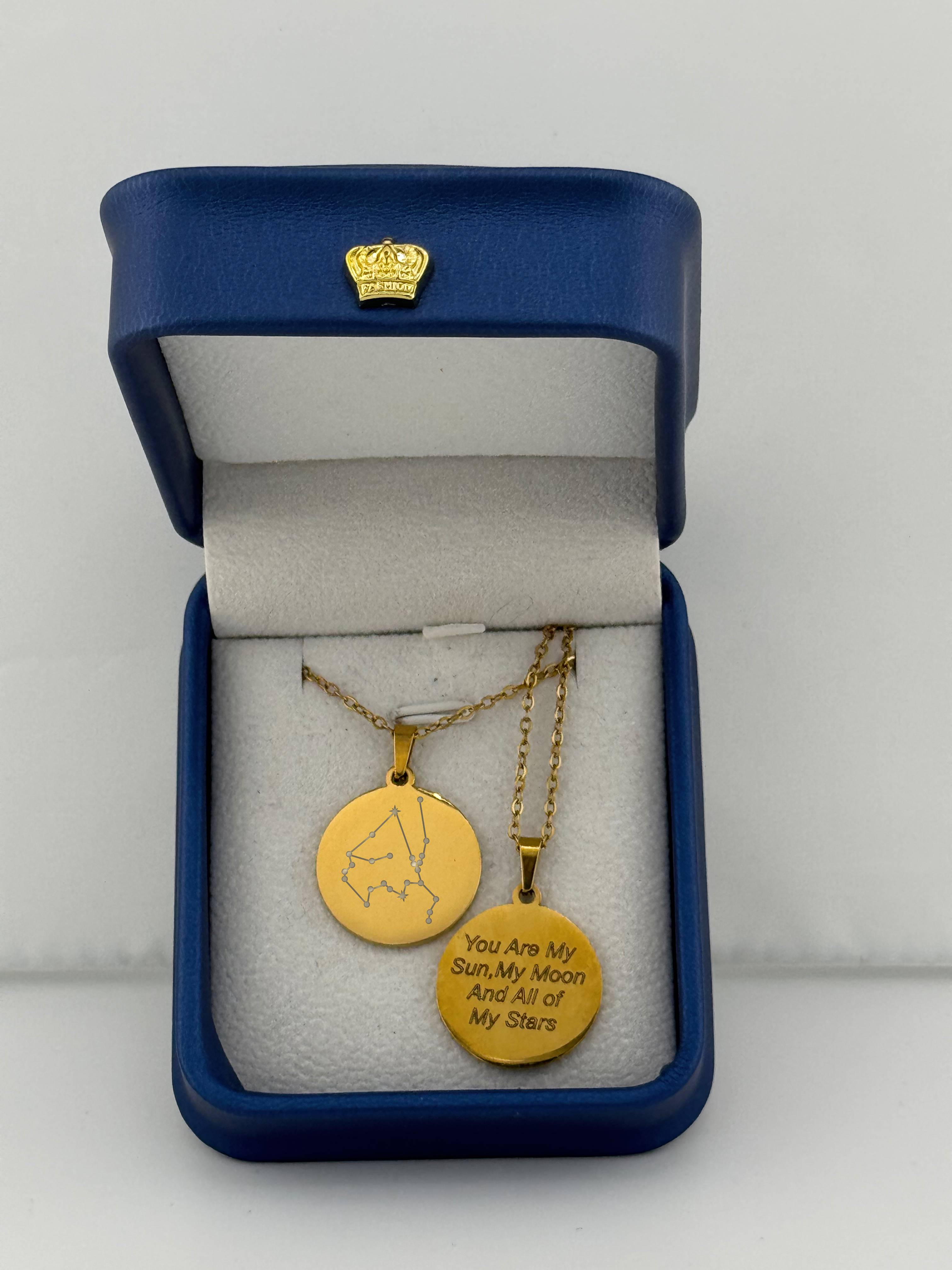 Gold Taurus and Aquarius zodiac medallion necklaces, one with constellation and one with custom engraved message 'you are my sun, my moon, and all of my stars'
