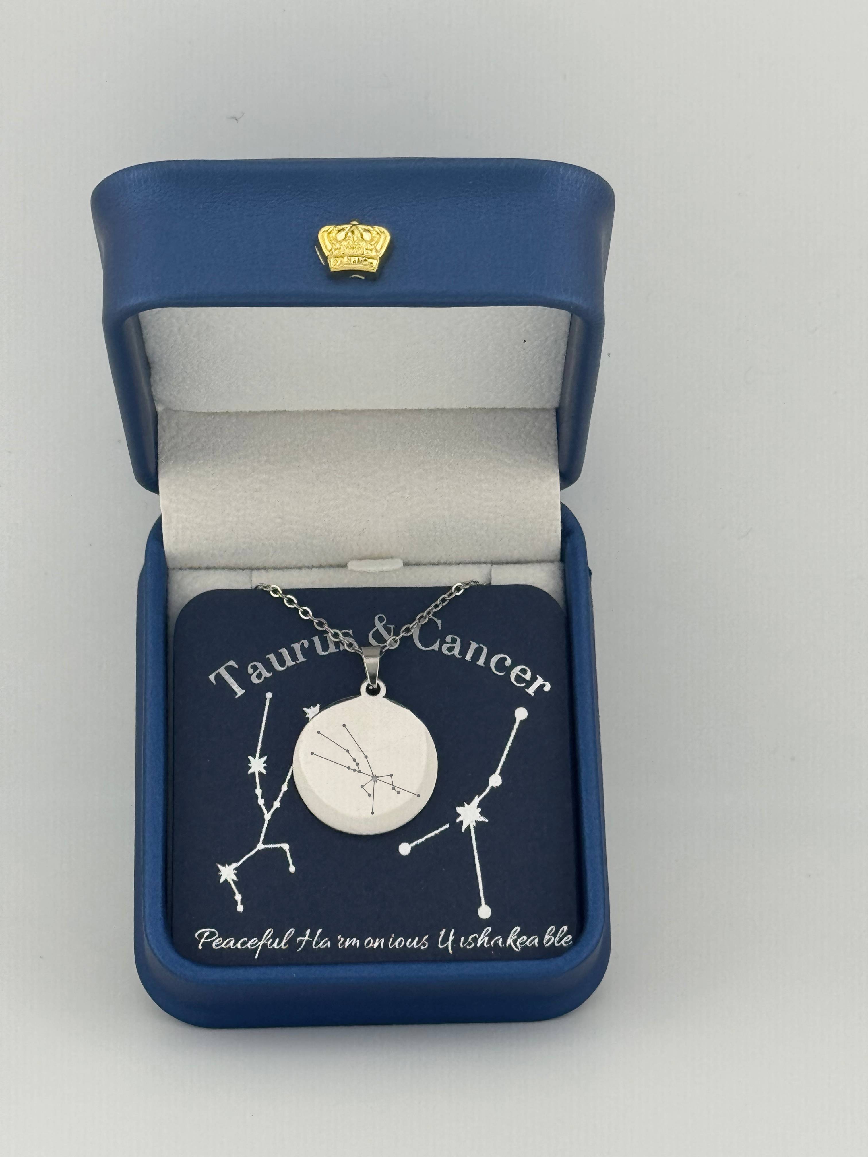 Silver Taurus + Cancer constellation medallion necklace in gift box with silver foil zodiac card
