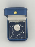 Silver Taurus + Leo constellation medallion necklace in gift box with silver foil zodiac card
