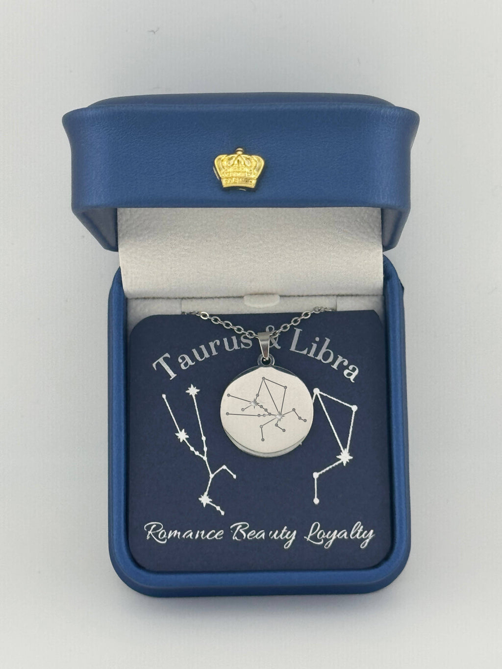 Silver Taurus + Libra constellation medallion necklace in gift box with silver foil zodiac card
