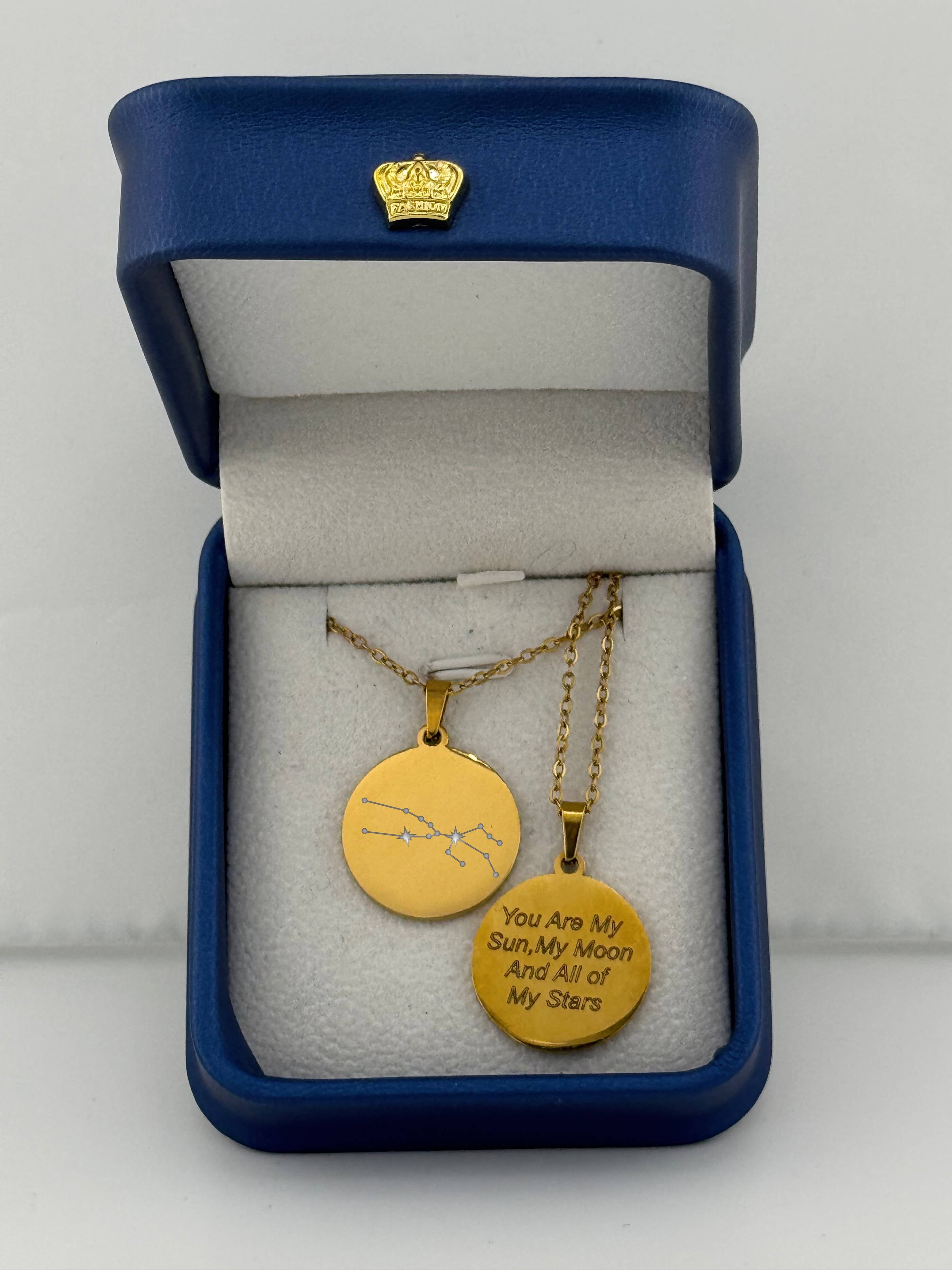 Gold Aries + Taurus zodiac medallion necklaces, one with custom engraved message 'you are my sun, my moon, and all of my stars'